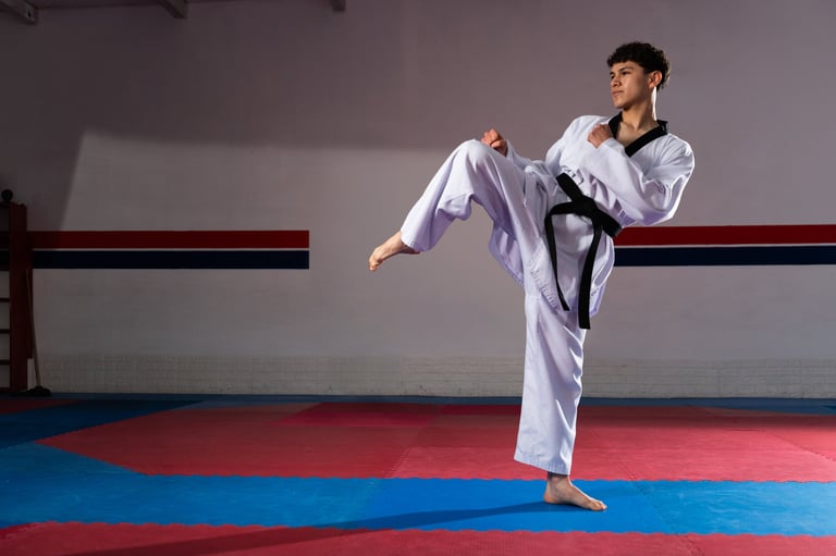 Teenager practicing taekwondo kicks