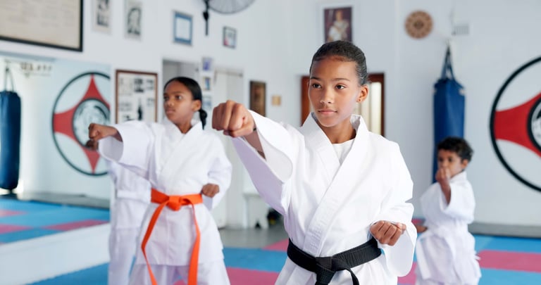 Children ages 8-12 practicing martial arts in dojo